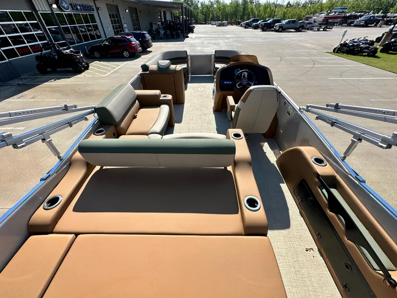 Slide: The Image of 2023 Tahoe Pontoon Cascade Versatile Rear Lounger interior with tan seating and steering console. - 23