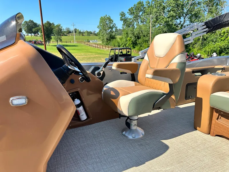 Slide: The Image of 2023 Tahoe Pontoon Cascade Versatile Rear Lounger interior with captain's chair and steering console. - 26