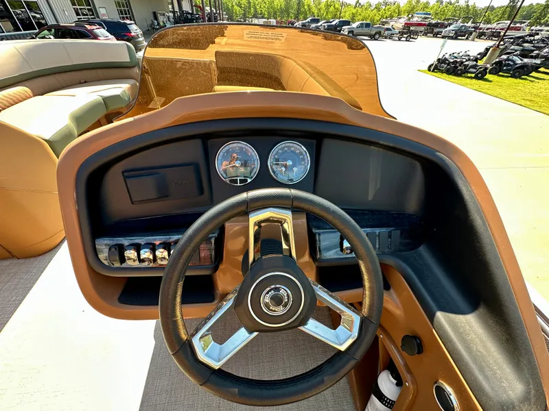 Slide: The Image of 2023 Tahoe Pontoon Cascade Versatile Rear Lounger dashboard with steering wheel and gauges. - 29