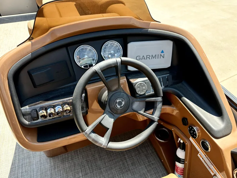 Slide: The Image of 2023 Tahoe Pontoon 25FT Cascade VRL Tritoon dashboard with Garmin navigation system. - 7