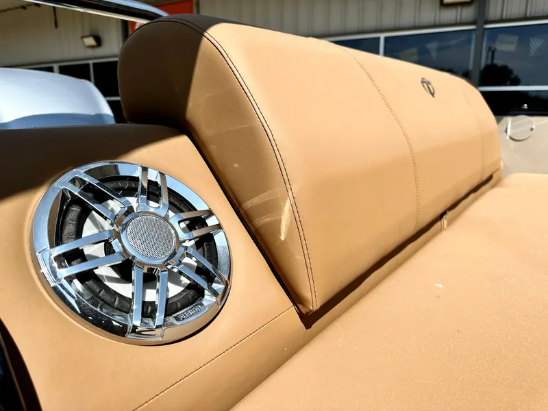 Slide: The Image of 2023 Tahoe Pontoon 25FT Cascade VRL Tritoon tan leather seating with built-in speaker. - 9