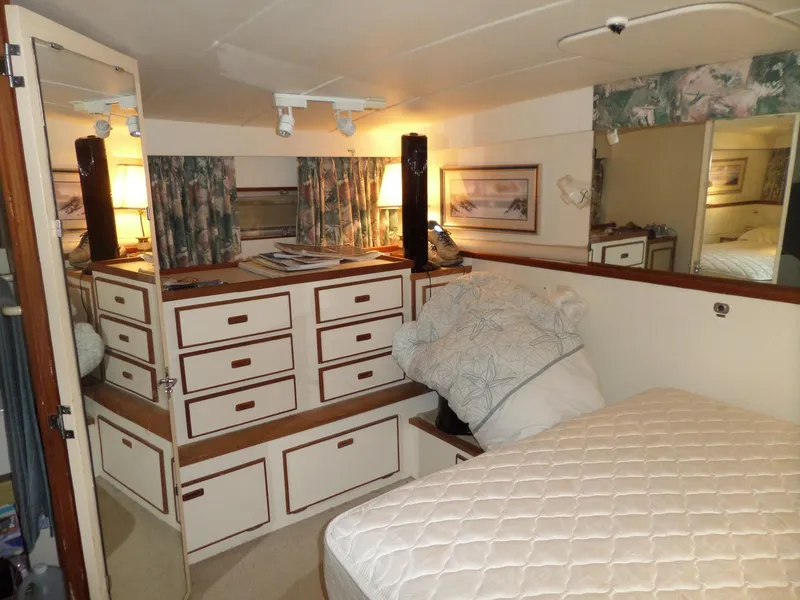 Slide: The Image of 1978 Bertram 42 Flybridge Motor Yacht interior with bed, drawers, and decor. - 15
