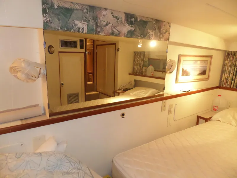 Slide: The Image of Interior of 1978 Bertram 42 Flybridge Motor Yacht with cozy cabin and mirror. - 18