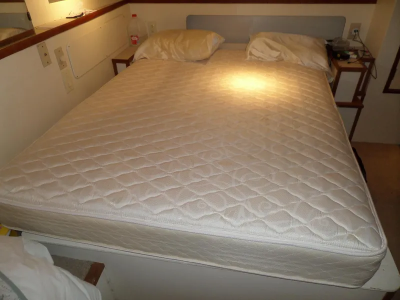 Slide: The Image of 1978 Bertram 42 Flybridge Motor Yacht cabin with double bed and pillows. - 20