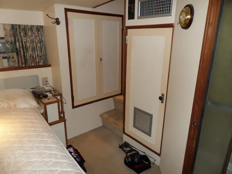 Slide: The Image of 1978 Bertram 42 Flybridge Motor Yacht interior with bed, closet, and carpeted steps. - 21