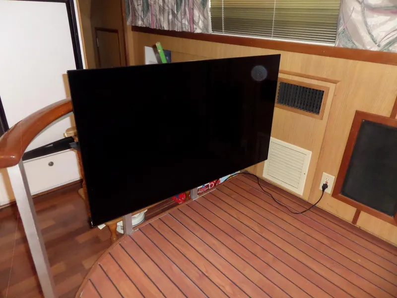 Slide: The Image of Interior of 1978 Bertram 42 Flybridge Motor Yacht with mounted flat-screen TV. - 23
