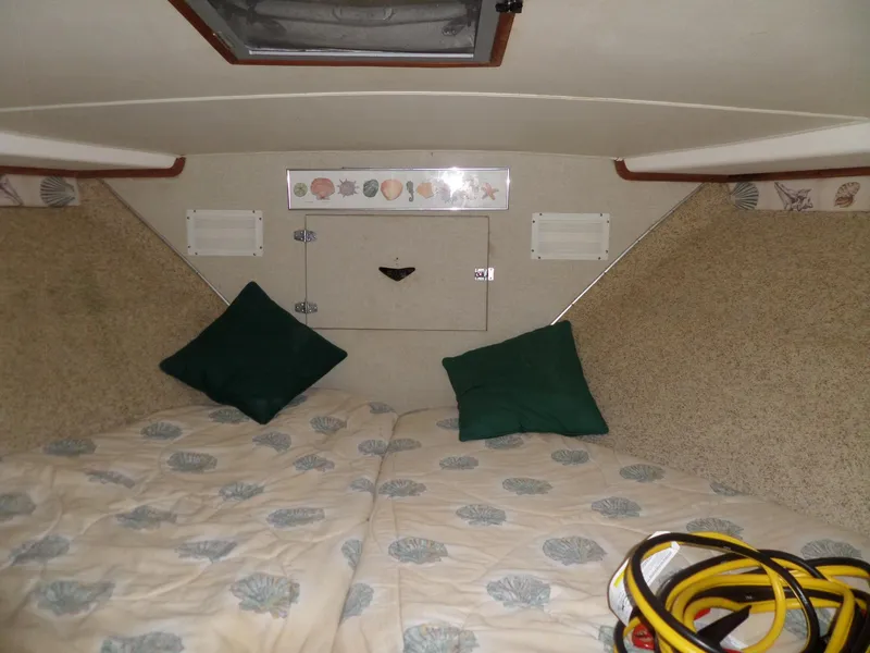 Slide: The Image of Cozy cabin interior of a 1978 Bertram 42 Flybridge Motor Yacht with decorative bedding. - 25