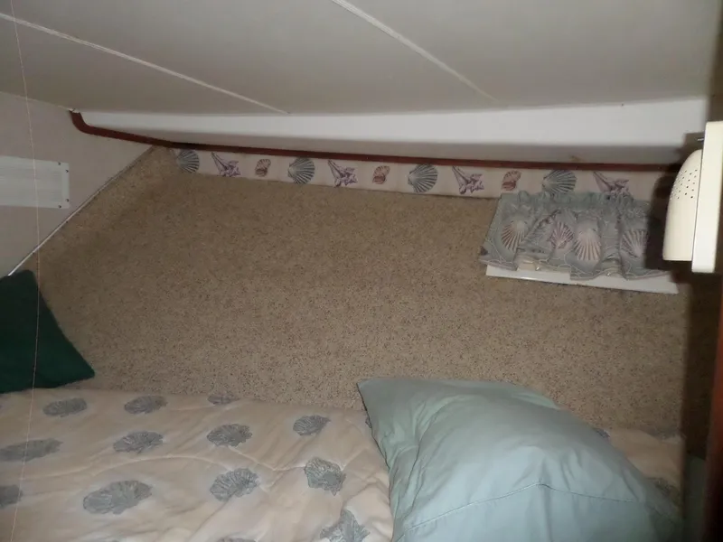 Slide: The Image of 1978 Bertram 42 Flybridge Motor Yacht cabin interior with patterned bedding and decorative trim. - 26