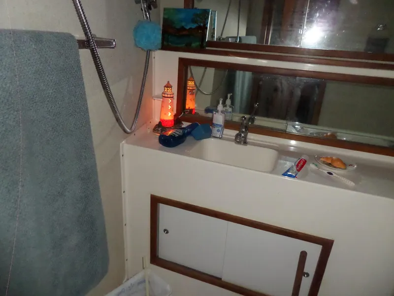 Slide: The Image of Bathroom interior of 1978 Bertram 42 Flybridge Motor Yacht with sink and toiletries. - 28