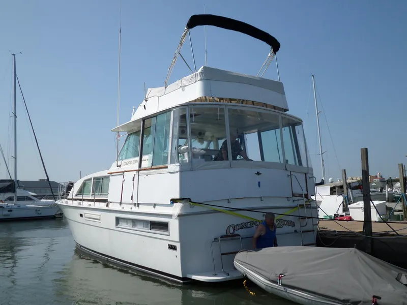 Slide: The Image of 1978 Bertram 42 Flybridge Motor Yacht docked at marina. - 3