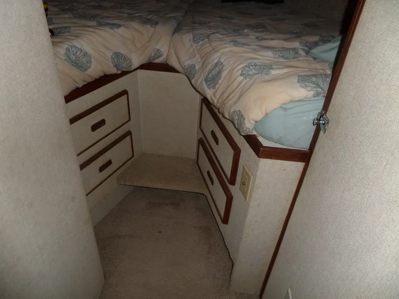 Slide: The Image of 1978 Bertram 42 Flybridge Motor Yacht cabin with twin beds and storage drawers. - 31