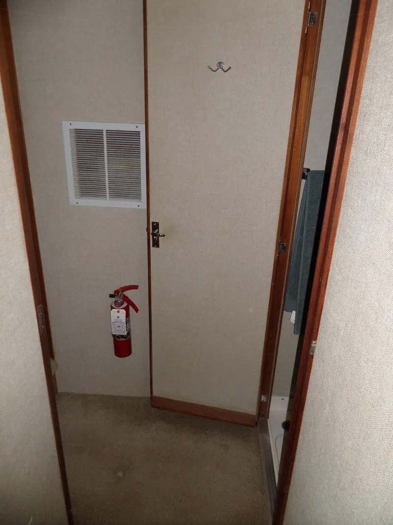 Slide: The Image of 1978 Bertram 42 Flybridge Motor Yacht interior with fire extinguisher and door. - 32