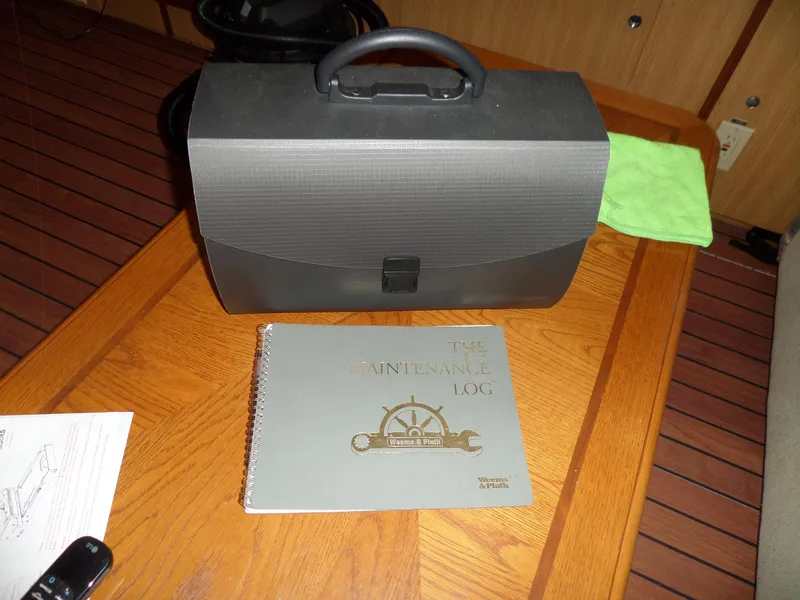 Slide: The Image of Black briefcase and maintenance logbook on wooden table, Bertram 42 Flybridge Motor Yacht, 1978. - 34