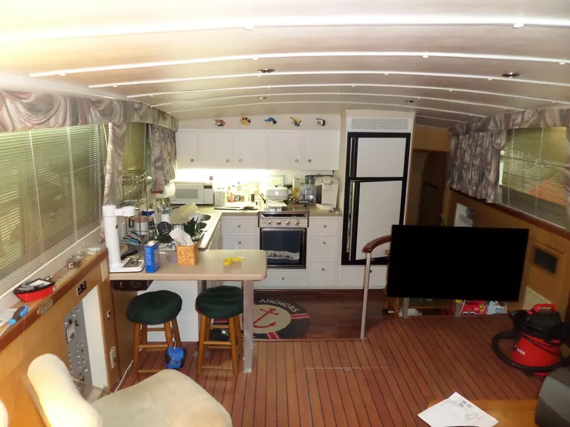 Slide: The Image of Interior of a 1978 Bertram 42 Flybridge Motor Yacht with kitchen and seating area. - 38
