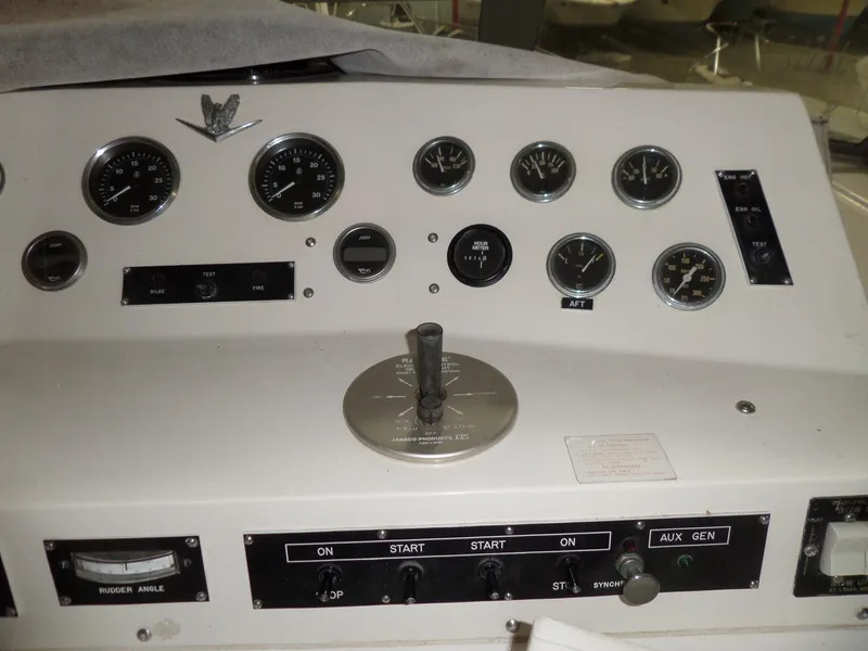 Slide: The Image of 1978 Bertram 42 Flybridge Motor Yacht dashboard with gauges and controls. - 44