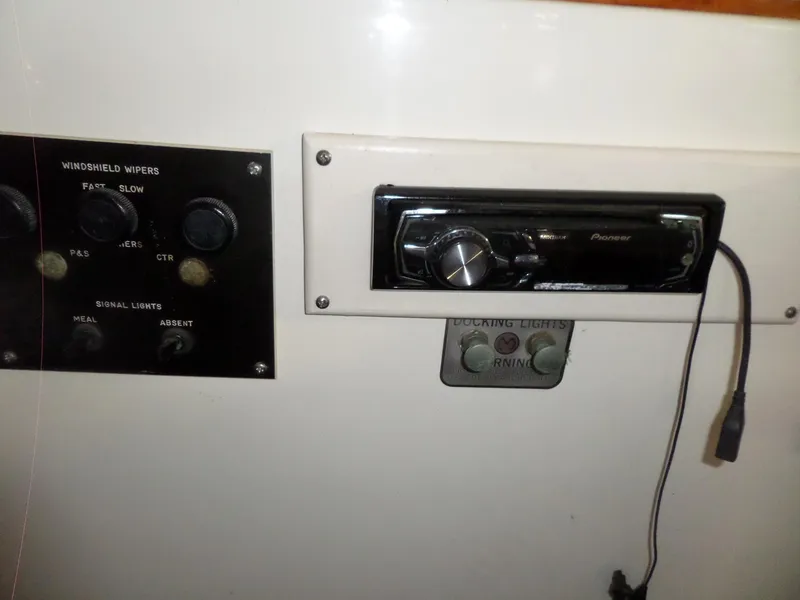 Slide: The Image of Control panel of a 1978 Bertram 42 Flybridge Motor Yacht with audio system and switches. - 47