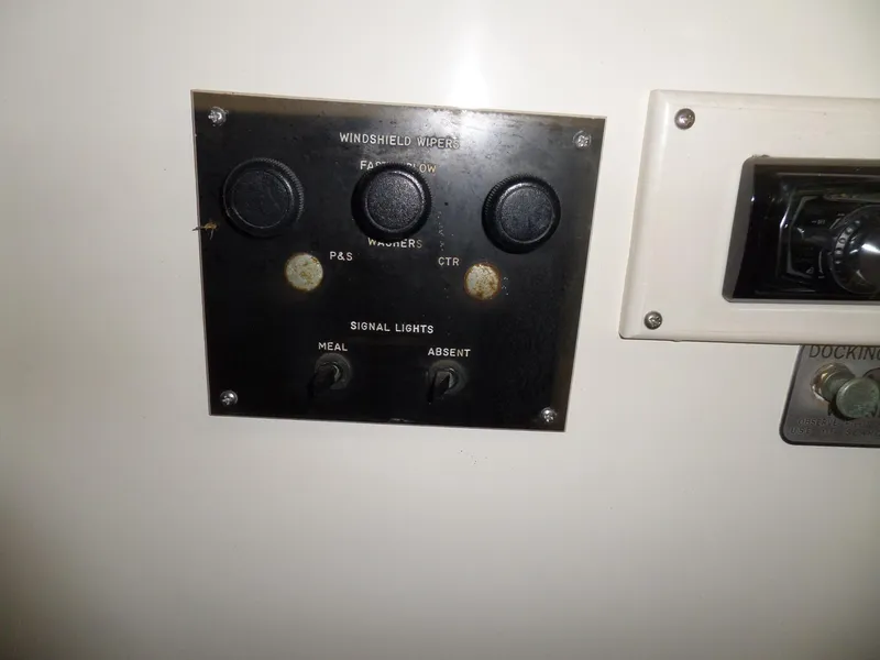 Slide: The Image of Control panel on a 1978 Bertram 42 Flybridge Motor Yacht, featuring windshield wiper and signal light switches. - 48