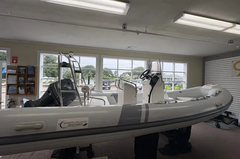 The Image of 2023 North Atlantic Inflatables RIB520H boat displayed indoors with modern design. - 0