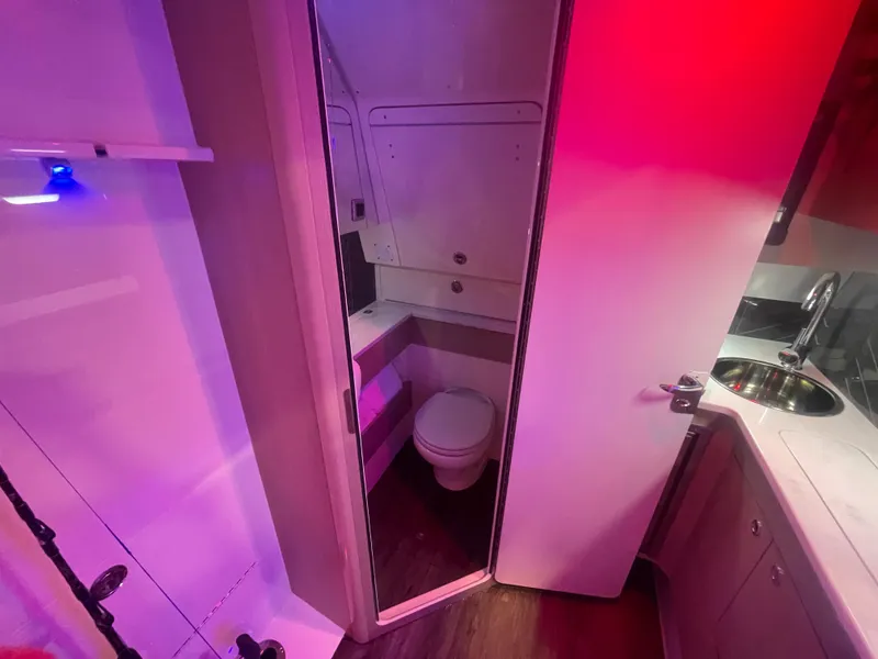 Slide: The Image of 2025 Scout 400 LXF boat interior bathroom with modern fixtures and ambient lighting. - 10