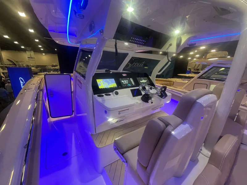 Slide: The Image of 2025 Scout 400 LXF boat interior with illuminated dashboard and seating. - 11