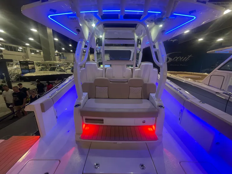 Slide: The Image of 2025 Scout 400 LXF boat interior with blue LED lighting at a boat show. - 13