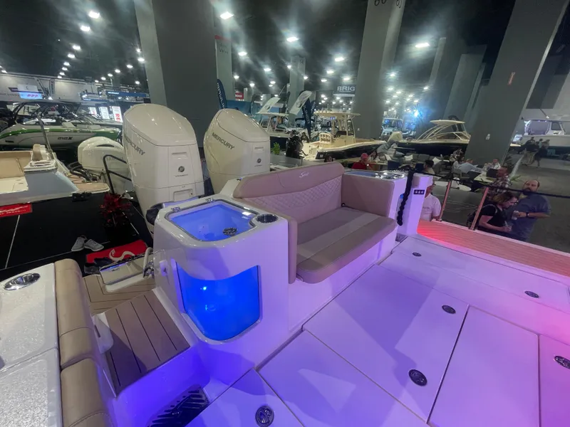 Slide: The Image of 2025 Scout 400 LXF boat interior at a boat show with Mercury engines. - 15