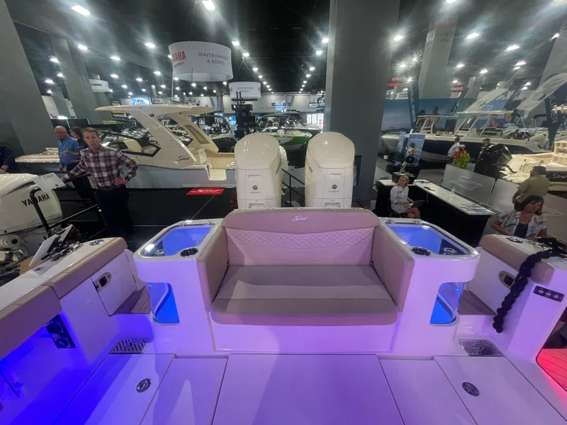 Slide: The Image of 2025 Scout 400 LXF boat interior at a boat show with Yamaha engines. - 16