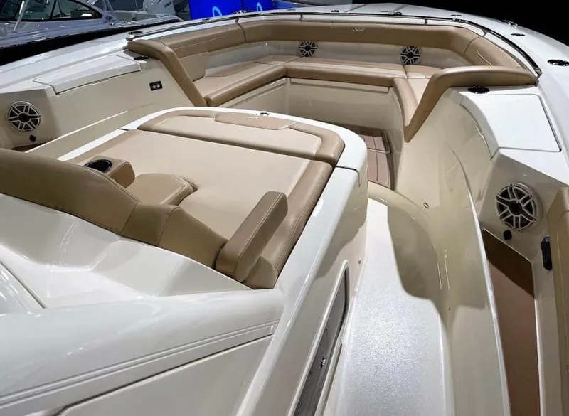 Slide: The Image of 2025 Scout 400 LXF boat interior with beige leather seating and built-in speakers. - 17