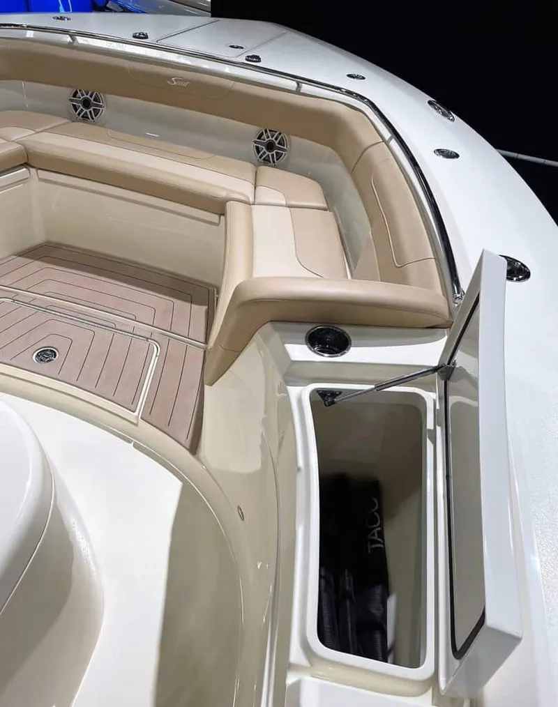 Slide: The Image of 2025 Scout 400 LXF boat interior with beige seating and open storage compartment. - 18