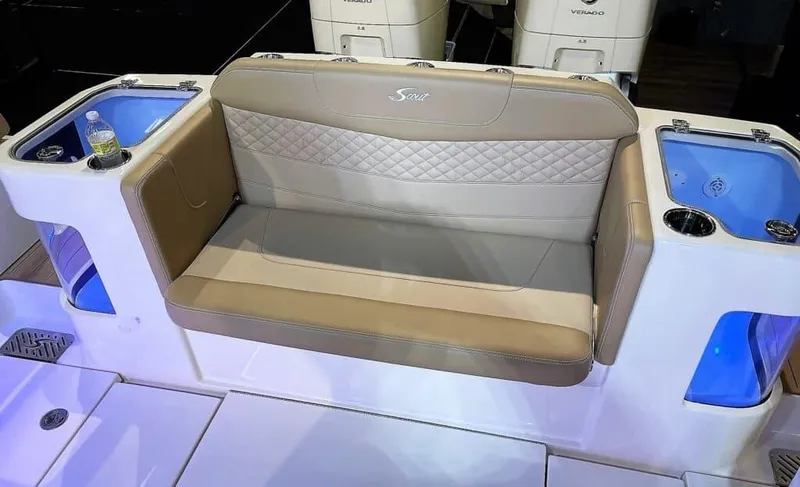 Slide: The Image of 2025 Scout 400 LXF boat with beige cushioned seating and integrated storage compartments. - 25