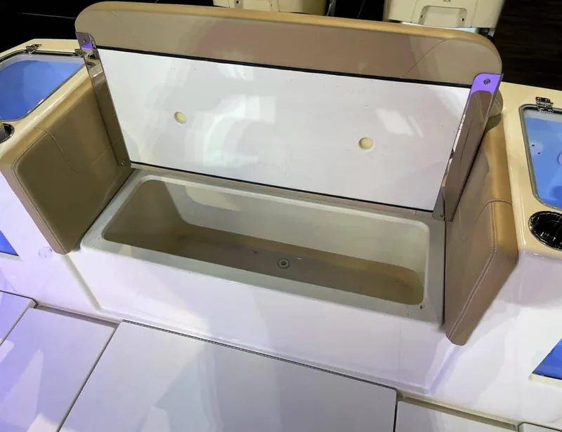 Slide: The Image of Open storage compartment on 2025 Scout 400 LXF boat with beige seating. - 28