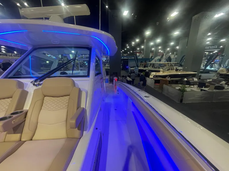Slide: The Image of 2025 Scout 400 LXF luxury boat interior with blue LED lighting at a boat show. - 3