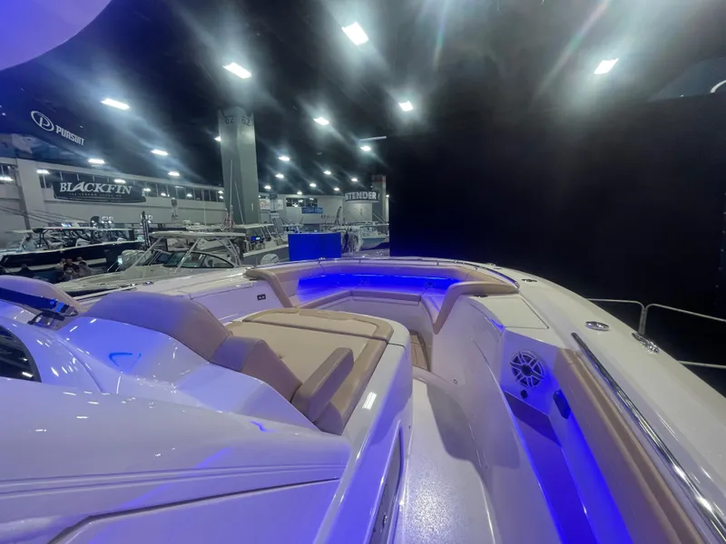 Slide: The Image of 2025 Scout 400 LXF boat interior with blue LED lighting at a boat show. - 5
