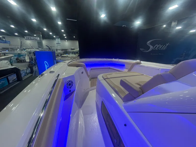 Slide: The Image of 2025 Scout 400 LXF boat interior with blue LED lighting at a boat show. - 6