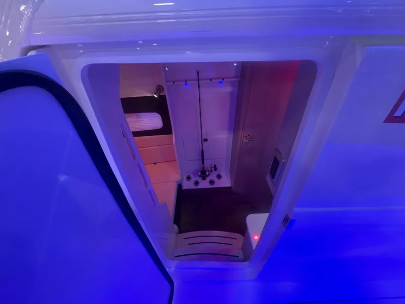 Slide: The Image of Interior view of 2025 Scout 400 LXF boat with blue ambient lighting. - 7