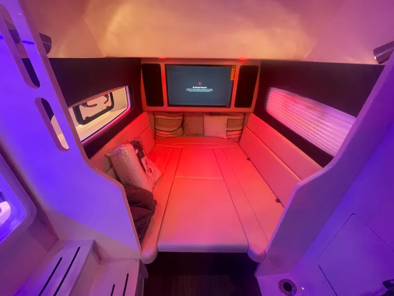 Slide: The Image of Interior cabin of 2025 Scout 400 LXF boat with cozy seating and ambient lighting. - 8