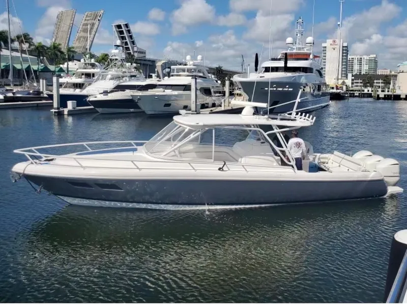 Slide: The Image of 2015 Intrepid 375 Walkaround boat docked in a marina with other yachts. - 1