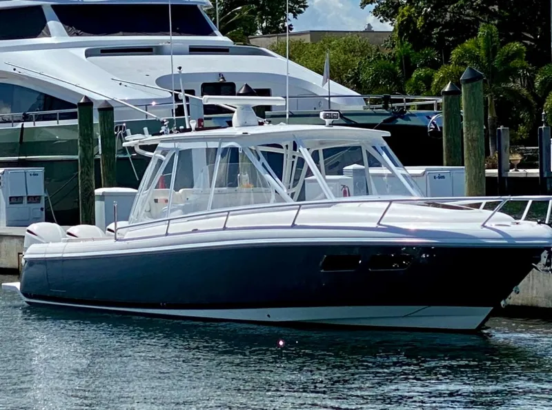 Slide: The Image of 2015 Intrepid 375 Walkaround boat docked in marina. - 10