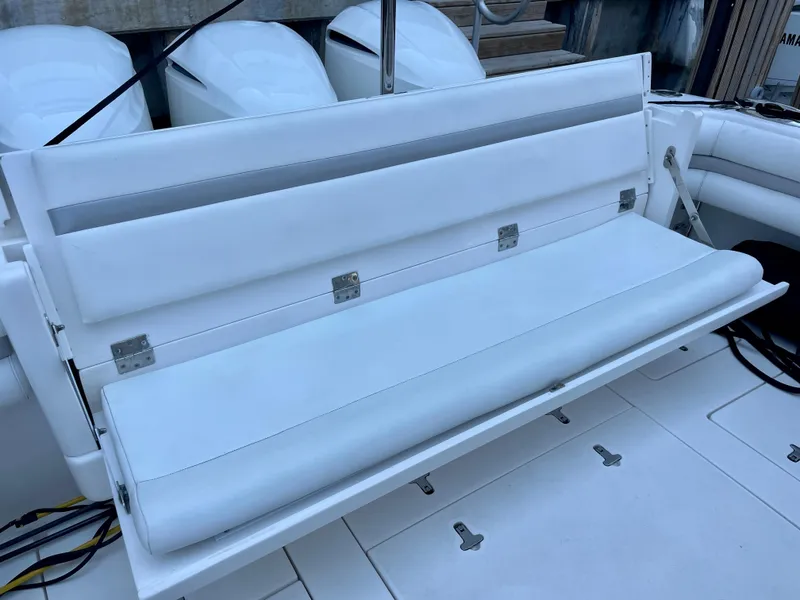 Slide: The Image of 2015 Intrepid 375 Walkaround boat with white cushioned seating. - 16