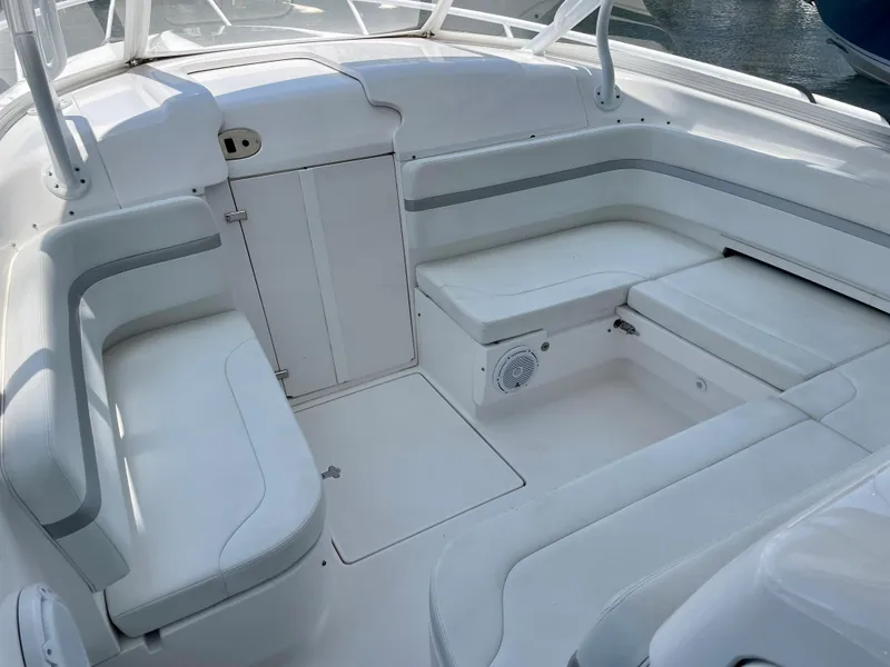 Slide: The Image of 2015 Intrepid 375 Walkaround boat interior with white seating and storage compartments. - 17