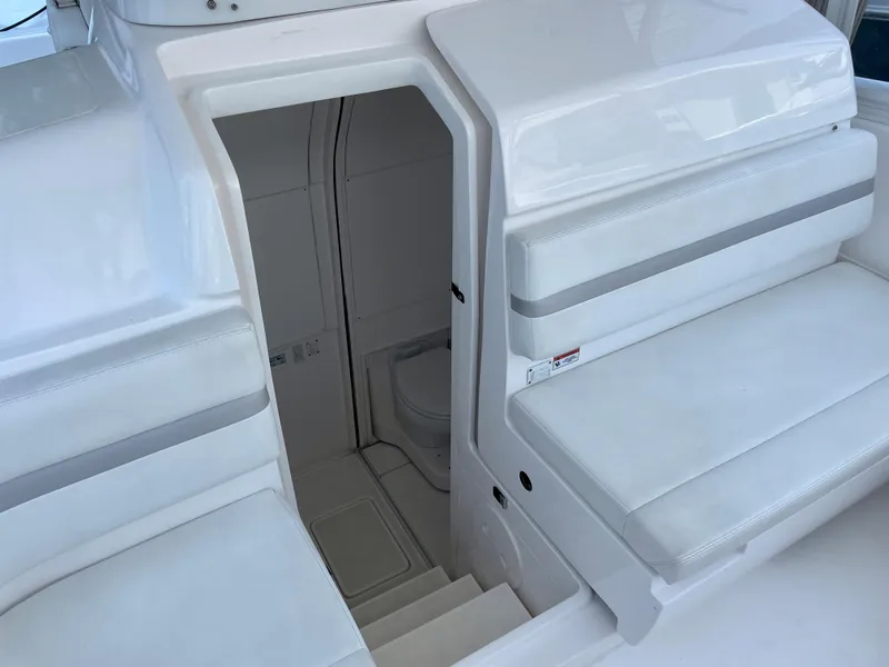 Slide: The Image of 2015 Intrepid 375 Walkaround boat interior with seating and cabin entrance. - 18