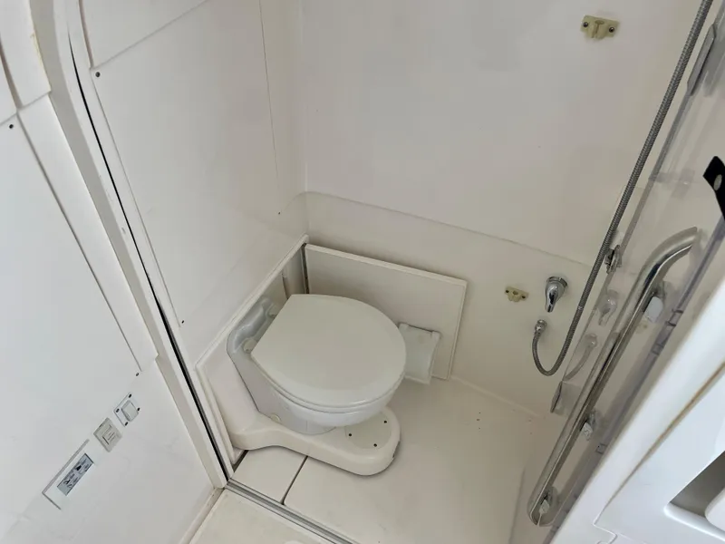 Slide: The Image of 2015 Intrepid 375 Walkaround boat bathroom with toilet and shower. - 19