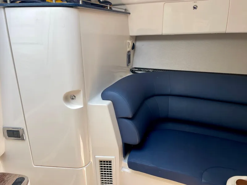 Slide: The Image of Interior of a 2015 Intrepid 375 Walkaround boat with blue seating. - 23