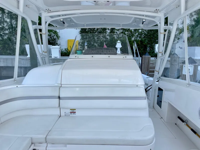 Slide: The Image of 2015 Intrepid 375 Walkaround boat interior with white seating and helm station. - 24