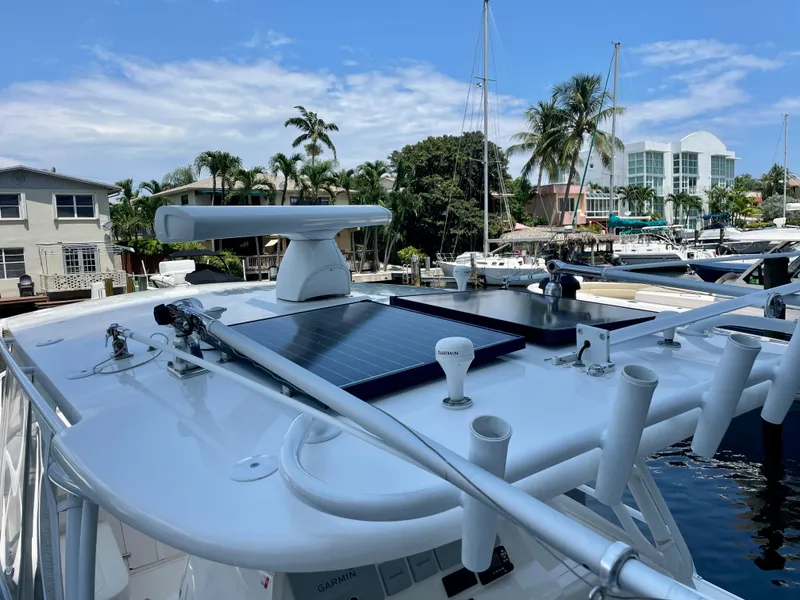 Slide: The Image of 2015 Intrepid 375 Walkaround boat with solar panels docked at marina. - 25