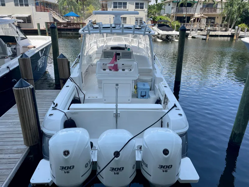 Slide: The Image of 2015 Intrepid 375 Walkaround boat docked with triple Yamaha 300 engines. - 26