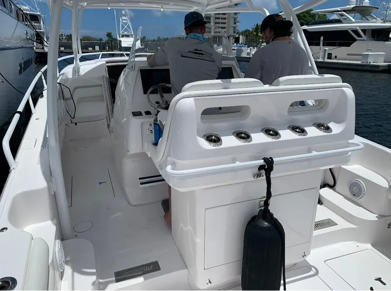 Slide: The Image of 2015 Intrepid 375 Walkaround boat interior with two people at the helm. - 5