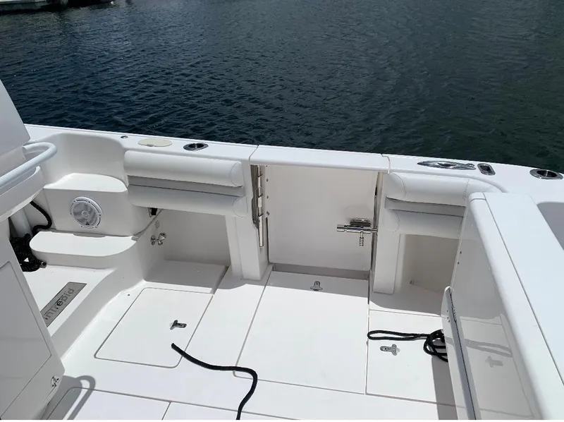 Slide: The Image of 2015 Intrepid 375 Walkaround boat deck with seating and storage compartments. - 6