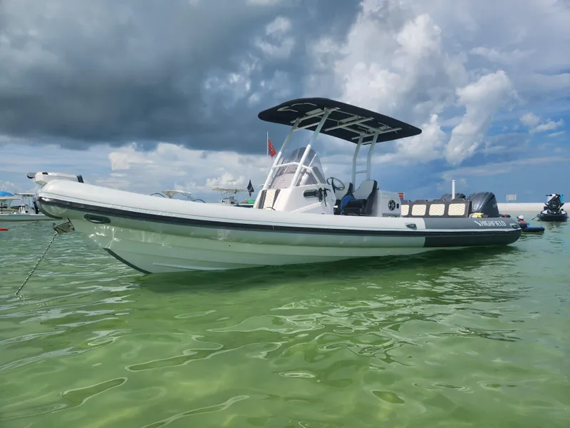 The Image of 2023 Highfield Sport 900 boat on calm water under cloudy sky. - 0