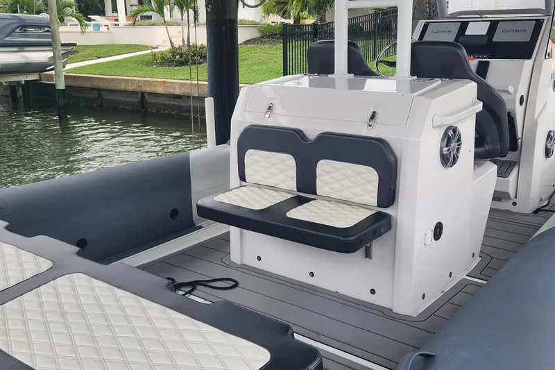 Slide: The Image of 2023 Highfield Sport 900 boat interior with cushioned seating and modern dashboard. - 10